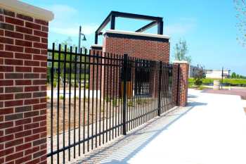 Brick column and steel fence along sidewalk