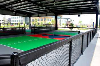 Covered pickleball courts with secure chain-link fencing