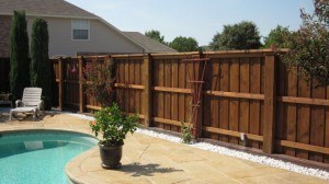 wood fence - stained wood board on board fence around pool area in backyard