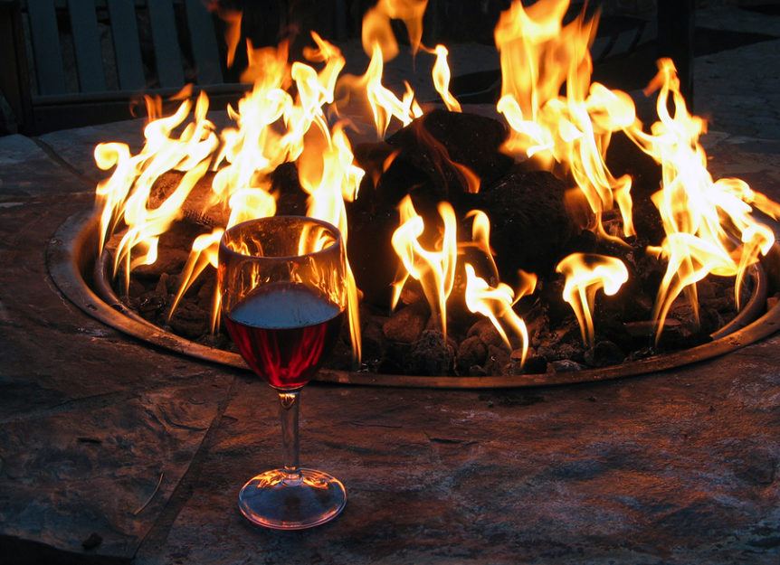 Fire pit maintenance - lit fire pit with wine glass