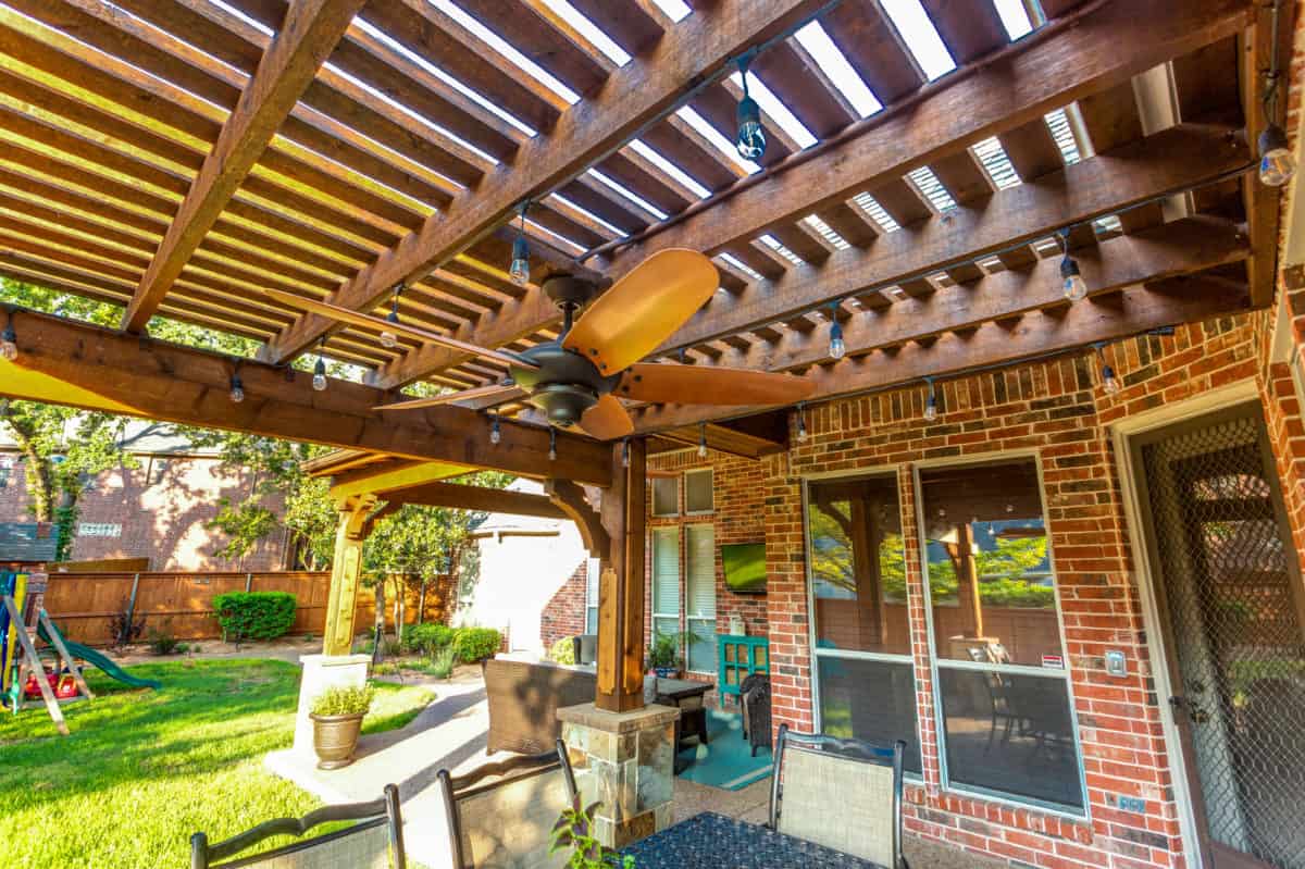 Game Day Space - Latticed wood patio cover with ceiling fan