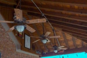 outdoor kitchen - ceiling fans with lights under patio cover