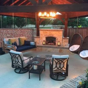 outdoor living for every season - outdoor living space under wood patio cover with outdoor fireplace