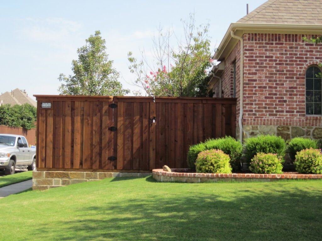 wood fence with stone retaining wall
