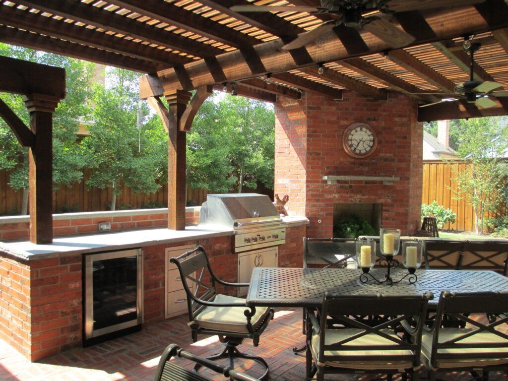 outdoor kitchen under pergola with fireplace
